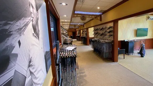 Club racks and fitting bays inside the Carl's Golfland store