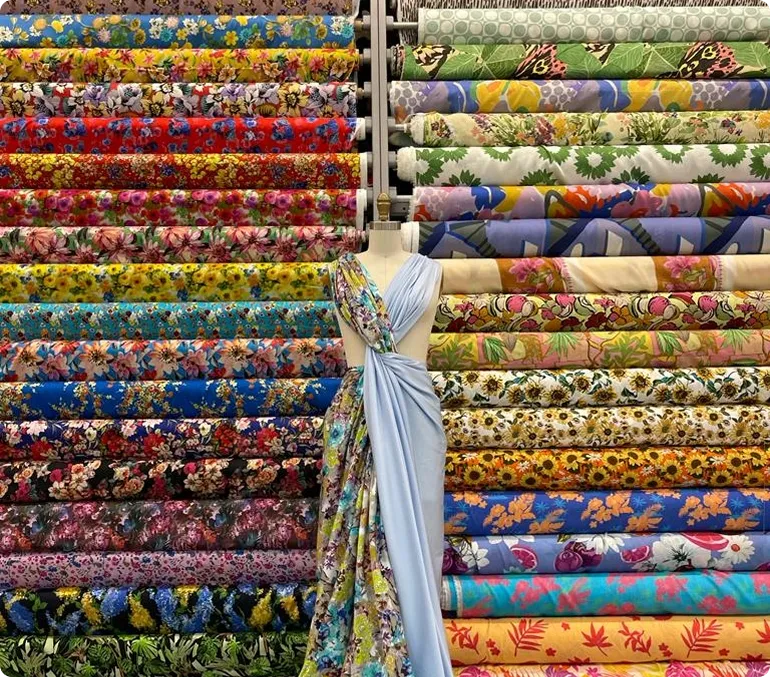 Bolts of printed fabric on the shelves at Mood Fabrics