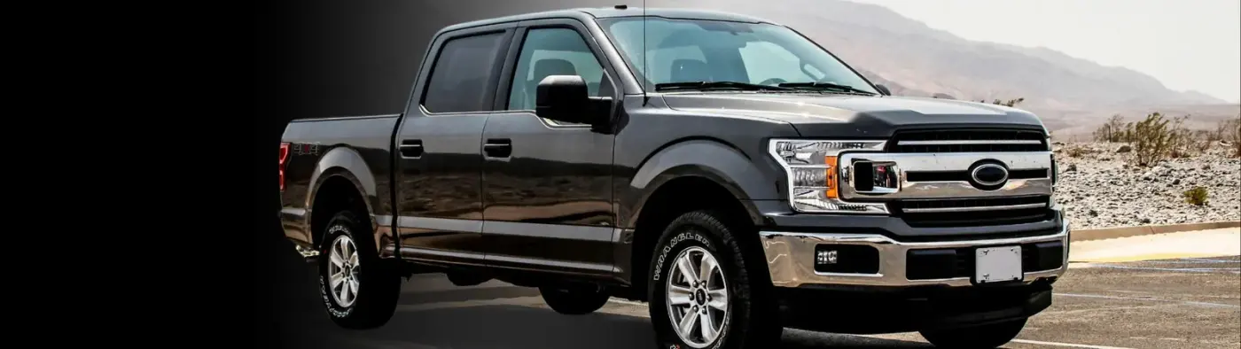 A black pickup truck with running boards